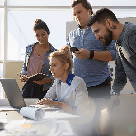 group of people looking at computer monitor