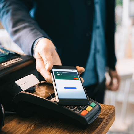 man paying cashier with mobile phone