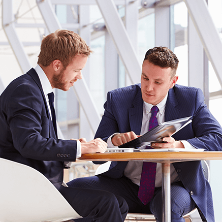 two business men looking over reports