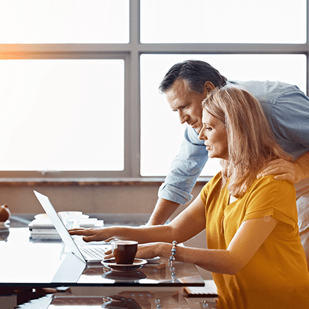 couple reviewing financial plans on laptop