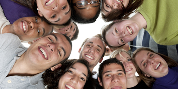 Students leaning over the camera looking down