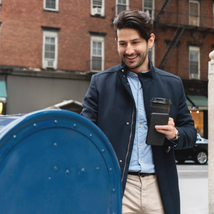 man putting letter in drop box