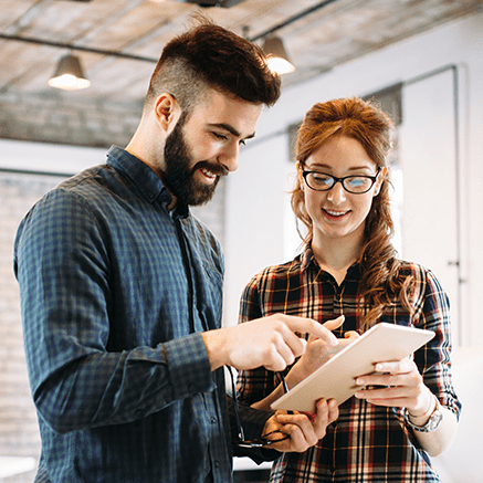 man and woman looking at tablet